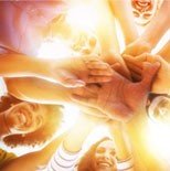 Group of light bearers holding hands from under